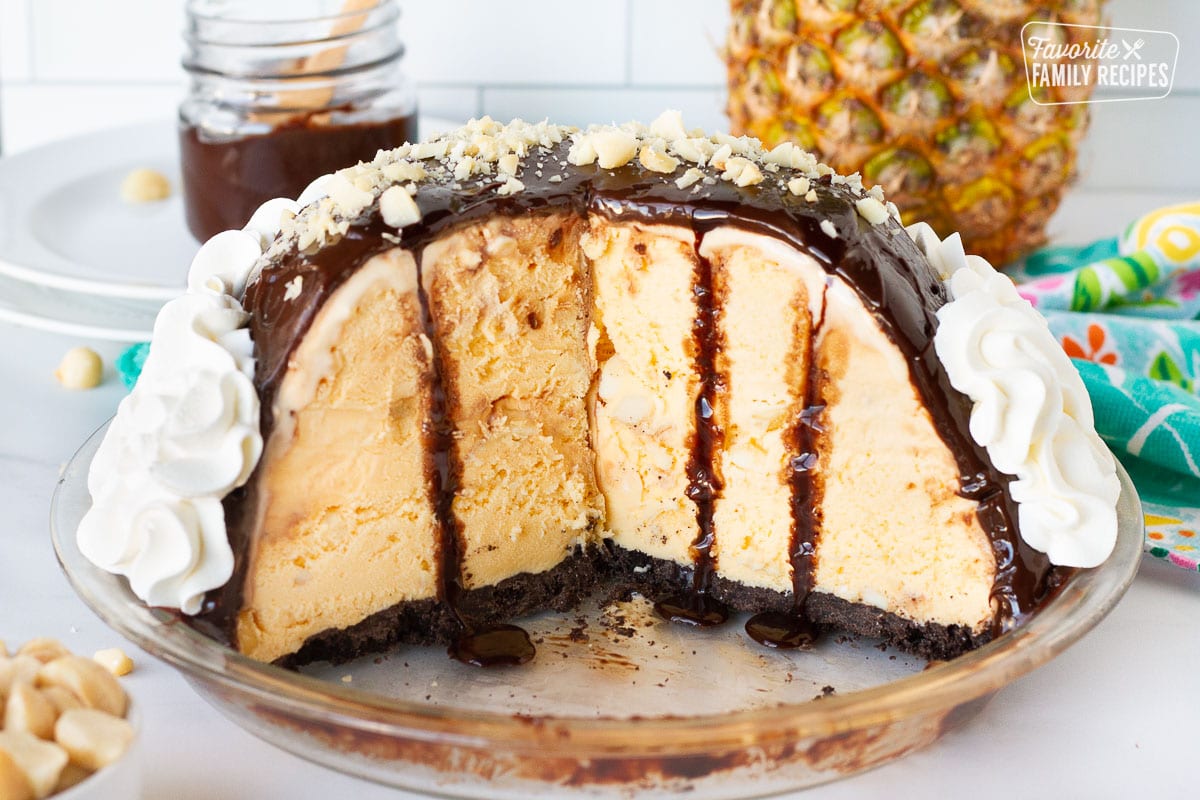 Inside view of Duke's Hula Pie missing a couple slices. Whipped cream, fudge sauce and chopped macadamia nuts on top.