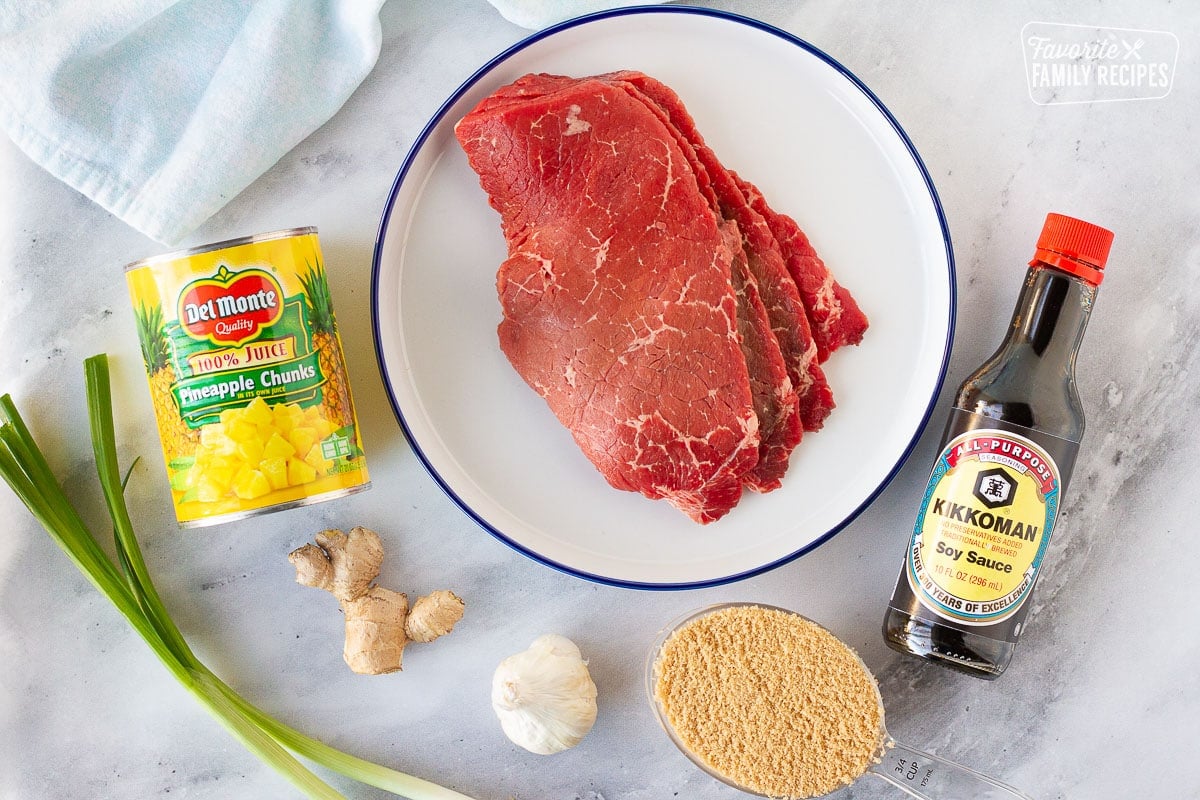 Ingredients for Hawaiian Beef Teriyaki including beef, soy sauce, brown sugar, ginger, garlic, pineapple and green onion.