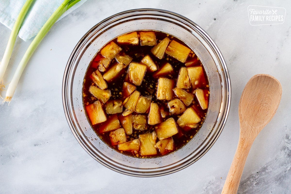 Bowl of marinade for Hawaiian Beef Teriyaki. Wooden spoon on the side.