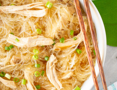 Large bowl of Hawaiian Style Chicken Long Rice Noodles garnished with green onions and chopsticks.