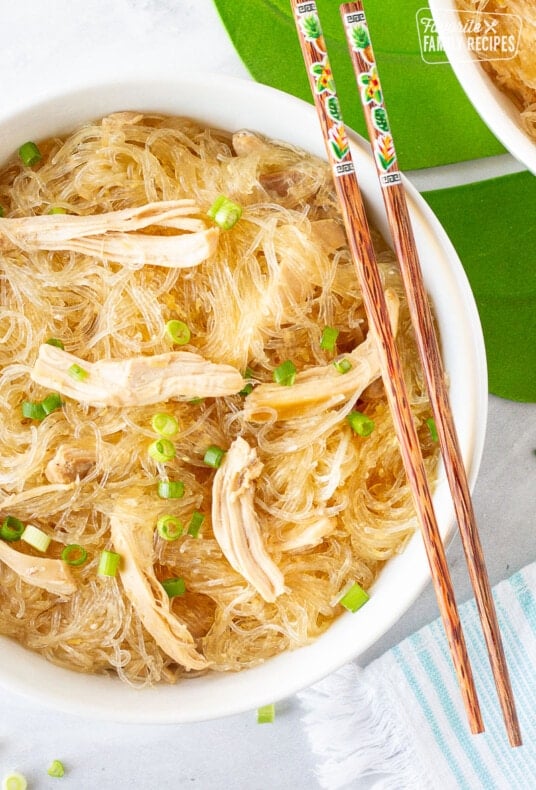 Large bowl of Hawaiian Style Chicken Long Rice Noodles garnished with green onions and chopsticks.