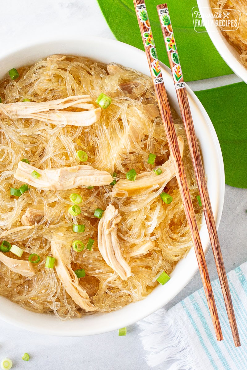 Large bowl of Hawaiian Style Chicken Long Rice Noodles garnished with green onions and chopsticks.