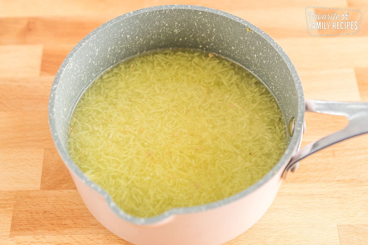 Grated ginger, water, and sugar in a pot
