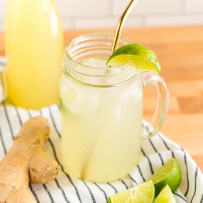 A mug of homemade ginger ale with a lime slice