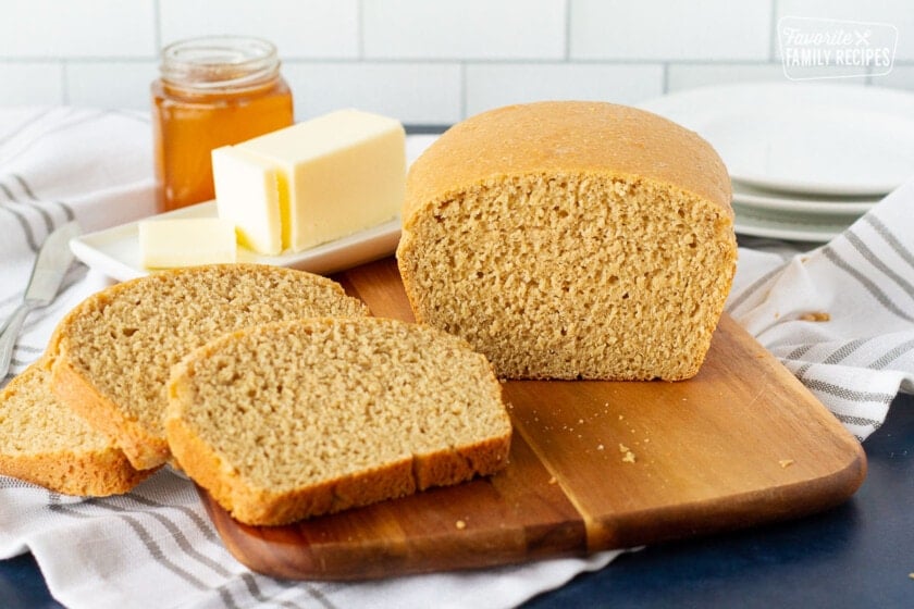 Honey Whole Wheat Bread on a cutting board with slices.