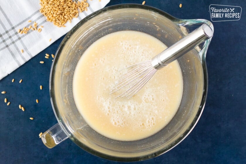 Mixing bowl of honey, shortening, yeast and salt mixture for Honey Whole Wheat Bread.