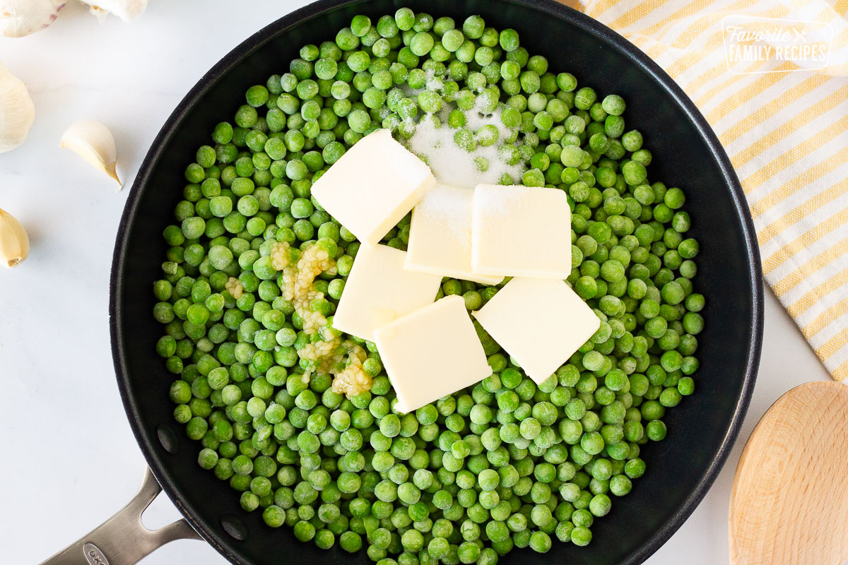 Skillet with frozen peas, garlic, butter and sugar for How to Cook Frozen Peas.
