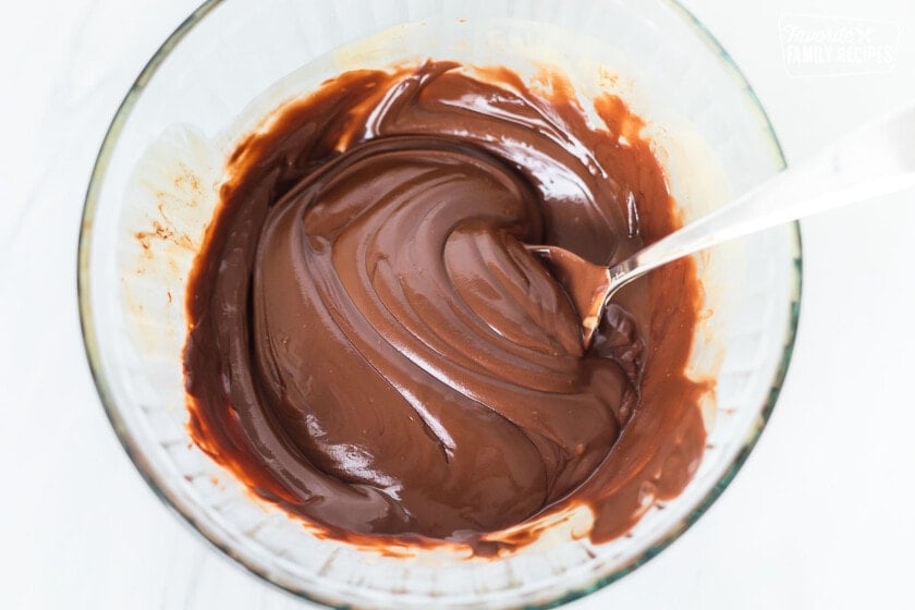 Melted chocolate in a bowl to make muddy buddies