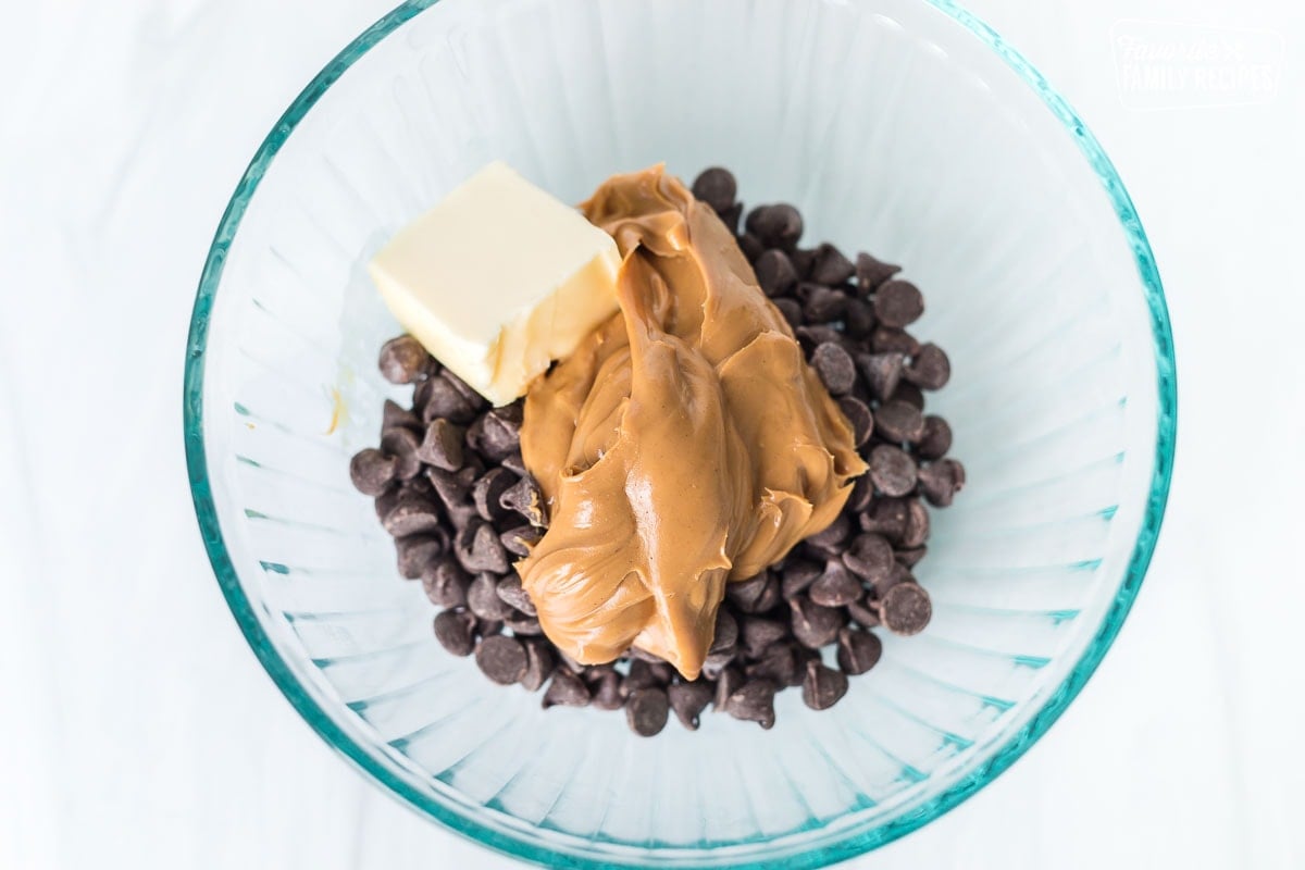 Chocolate chips, peanut butter, and butter in a glass bowl