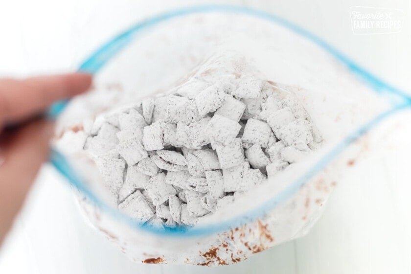 Muddy buddies in a bag with powdered sugar