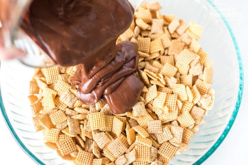 Melted chocolate being poured over Chex cereal