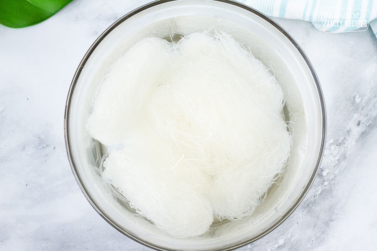 Bean Vermicelli noodles in a bowl of water for Hawaiian Style Chicken Long Rice Noodles.