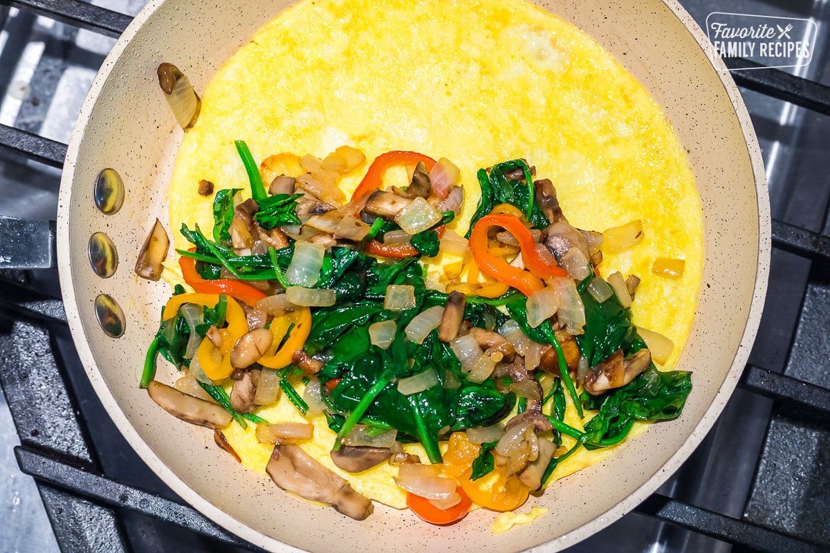 An omelette with veggies in a pan