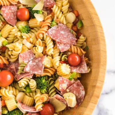 A large wooden bowl full of pasta salad