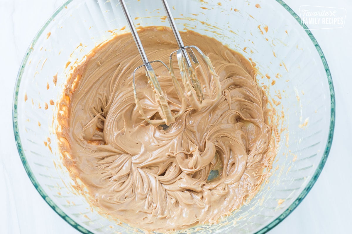 Peanut butter and softened butter creamed together in a bowl