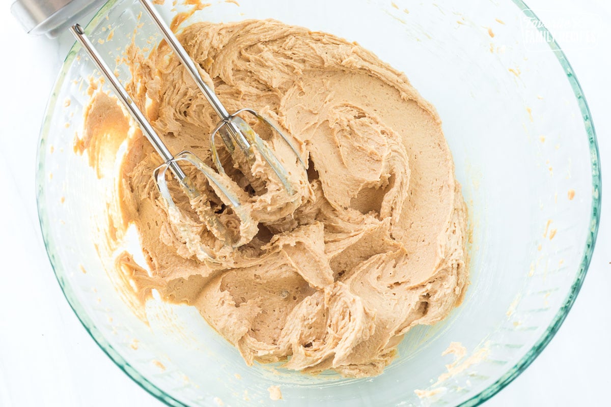 Peanut butter and sugar creamed together in a bowl to make peanut butter blossoms