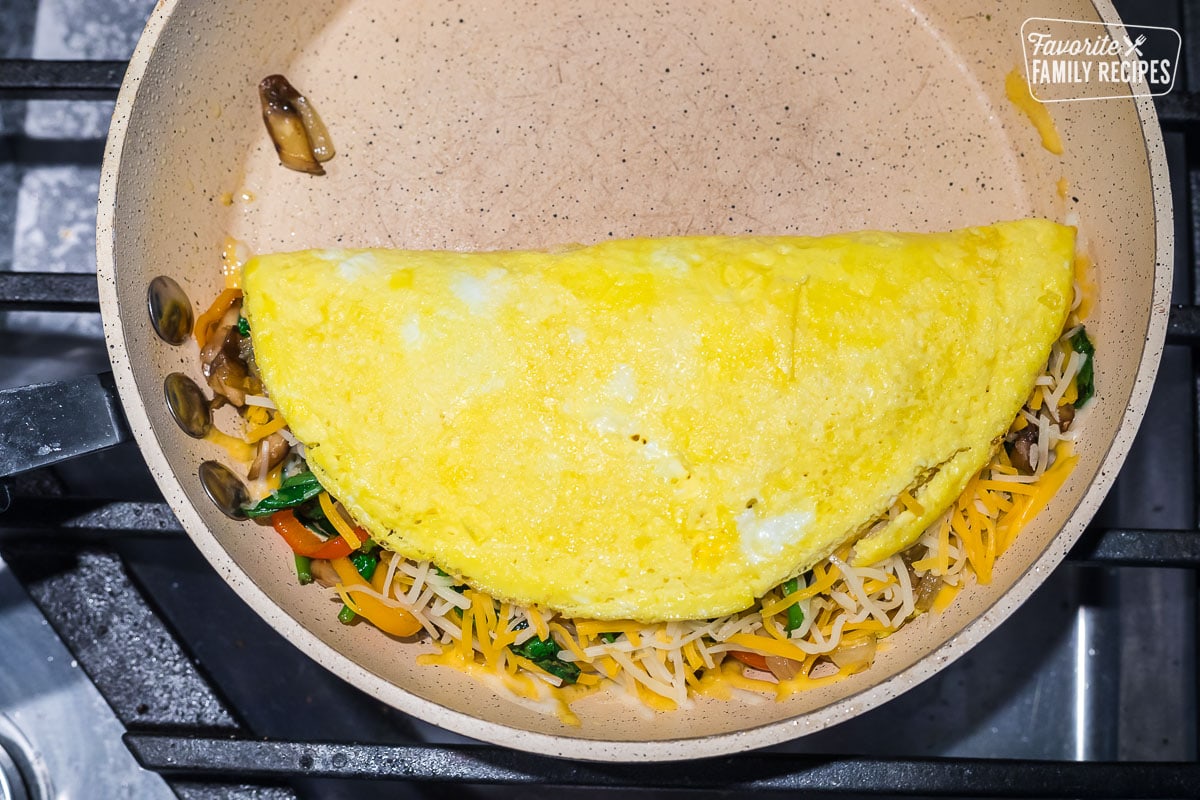 A veggie omelette folded over in a pan