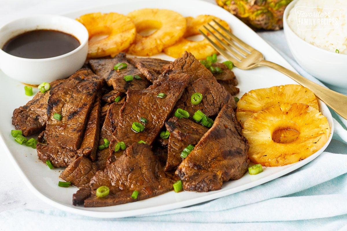 Plate of Hawaiian Beef Teriyaki with grilled pineapple. Side of white rice on the side.