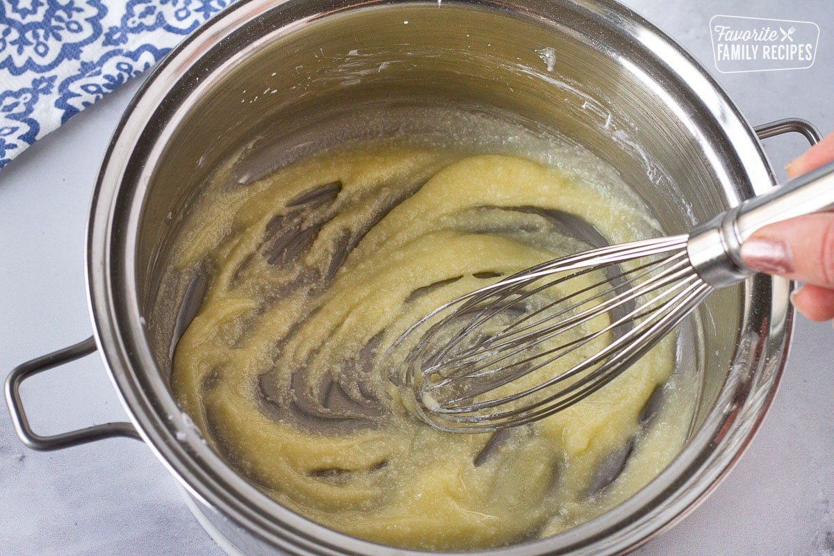 Whisk mixing a pan of roux for Cream Sauce for Baked Cod.