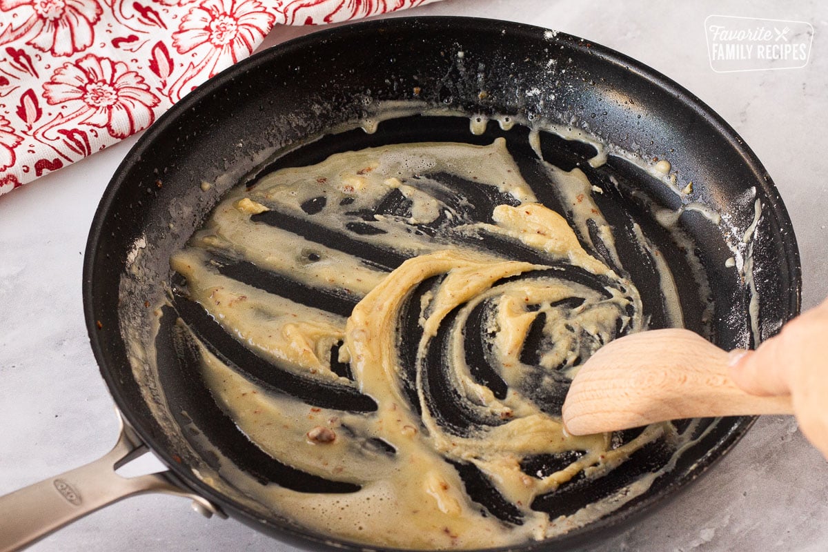 Wooden spoon stirring the roux in a skillet for Frikadeller (Danish Meatballs).