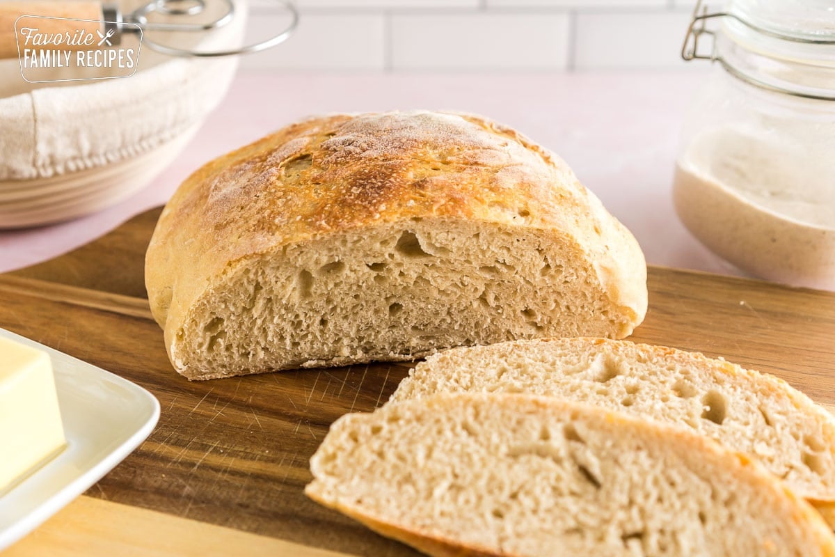 Sliced sourdough bread on a wooden cutting board