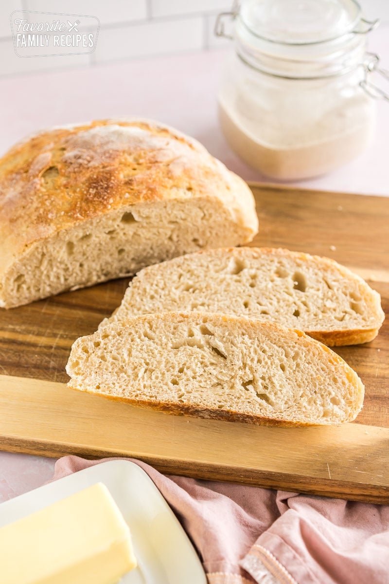 Sliced sourdough bread on a wooden cutting board