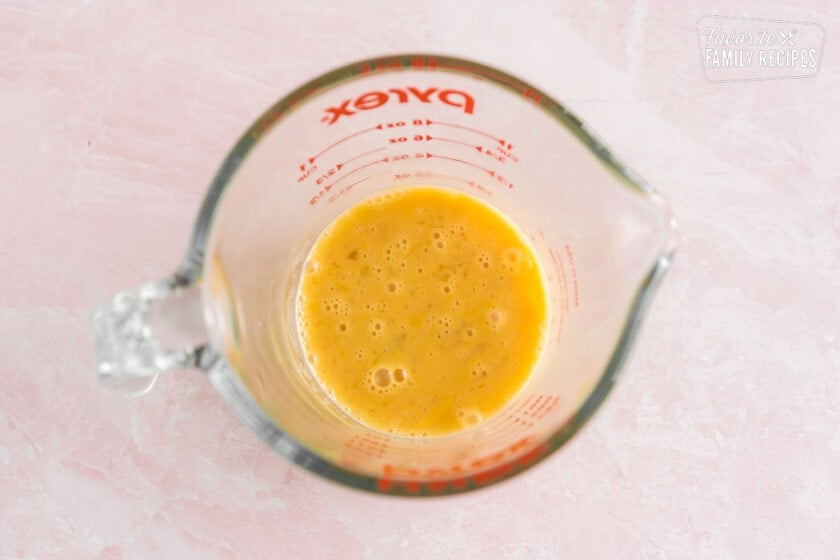 egg and vanilla in a measuring cup