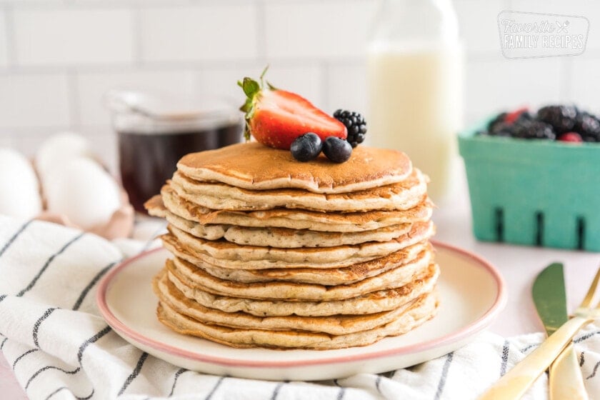 A stack of sourdough pancakes topped with berries