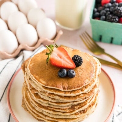 A stack of sourdough pancakes topped with berries