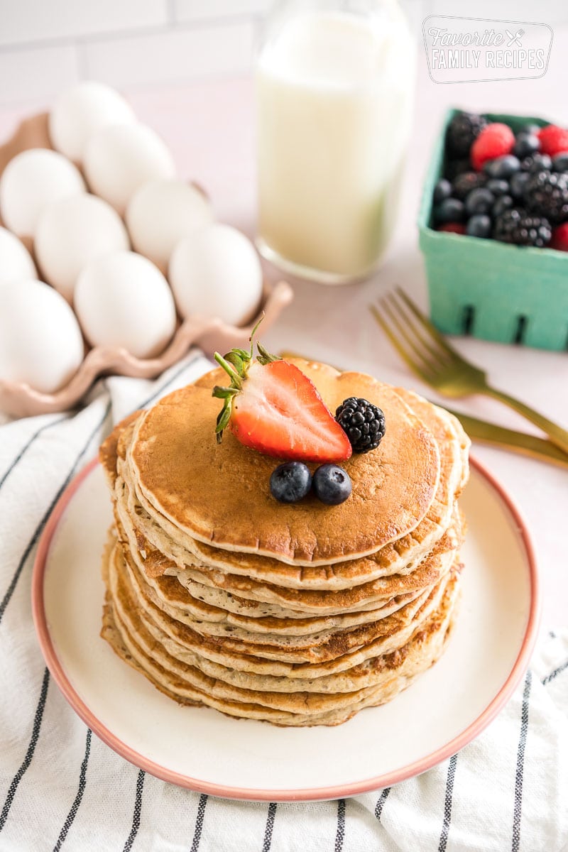 A stack of sourdough pancakes topped with berries