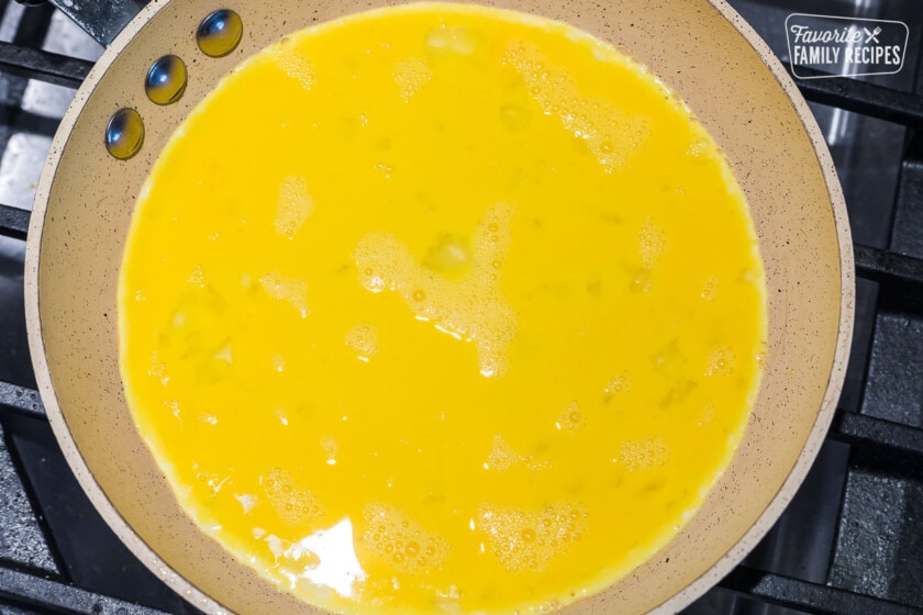 Beaten egg in a nonstick skillet to make an omelette