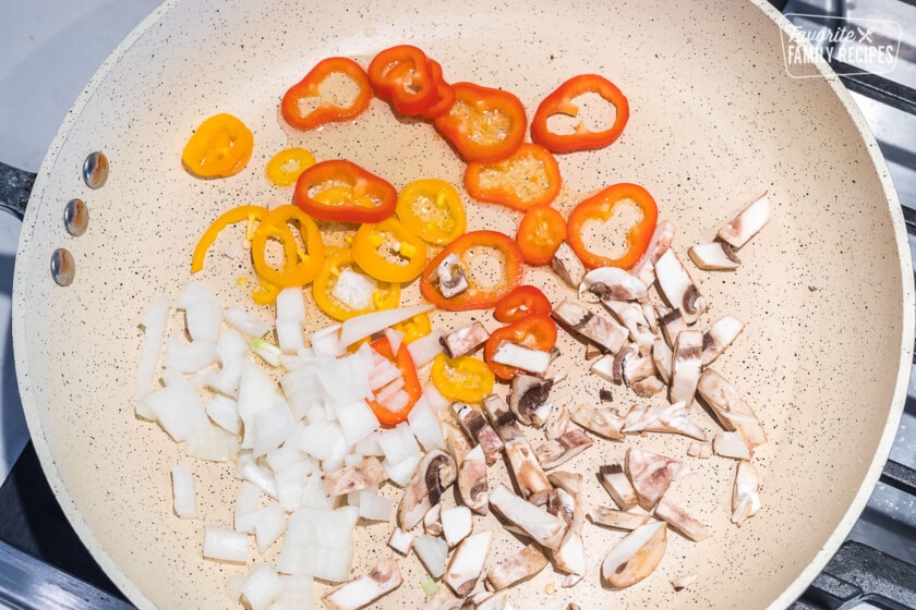 Onions, peppers, and mushrooms in a skillet