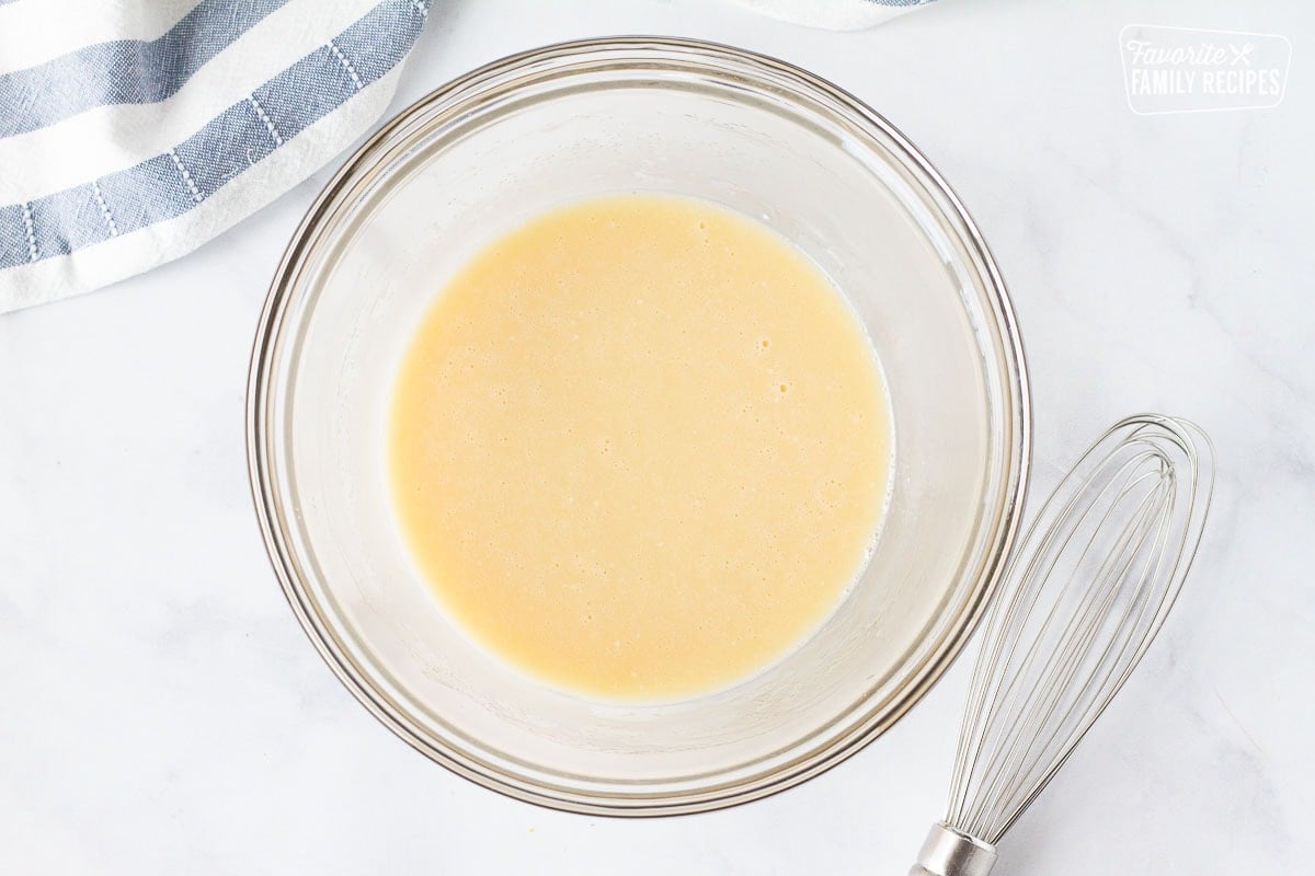 Bowl of Applebee's Oriental Chicken Salad dressing. Whisk on the side.