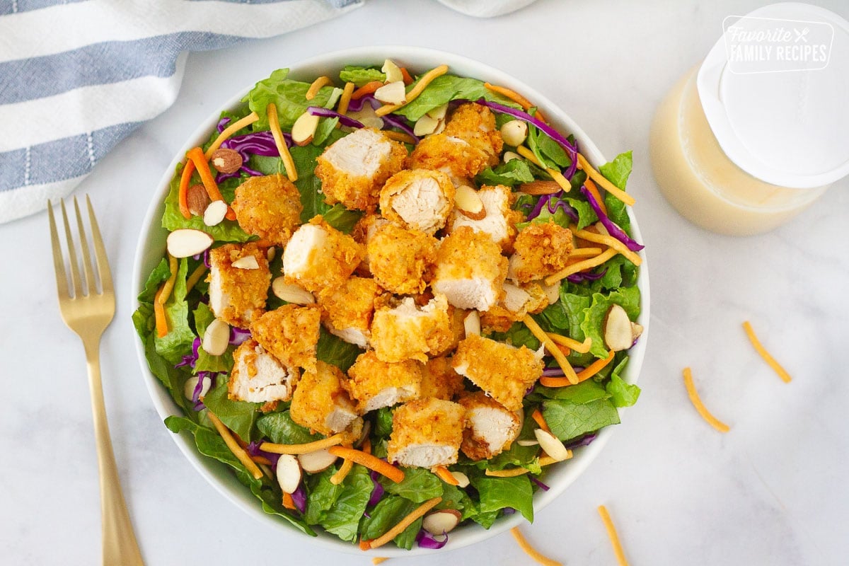 Bowl of Applebee's Oriental Chicken Salad. Homemade dressing on the side.