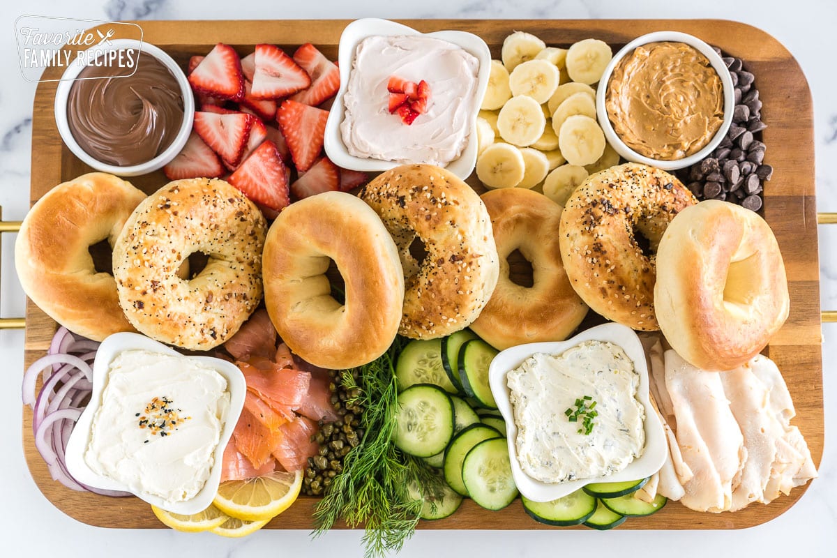 Brunch charcuterie board full of bagels, spreads, and toppings.