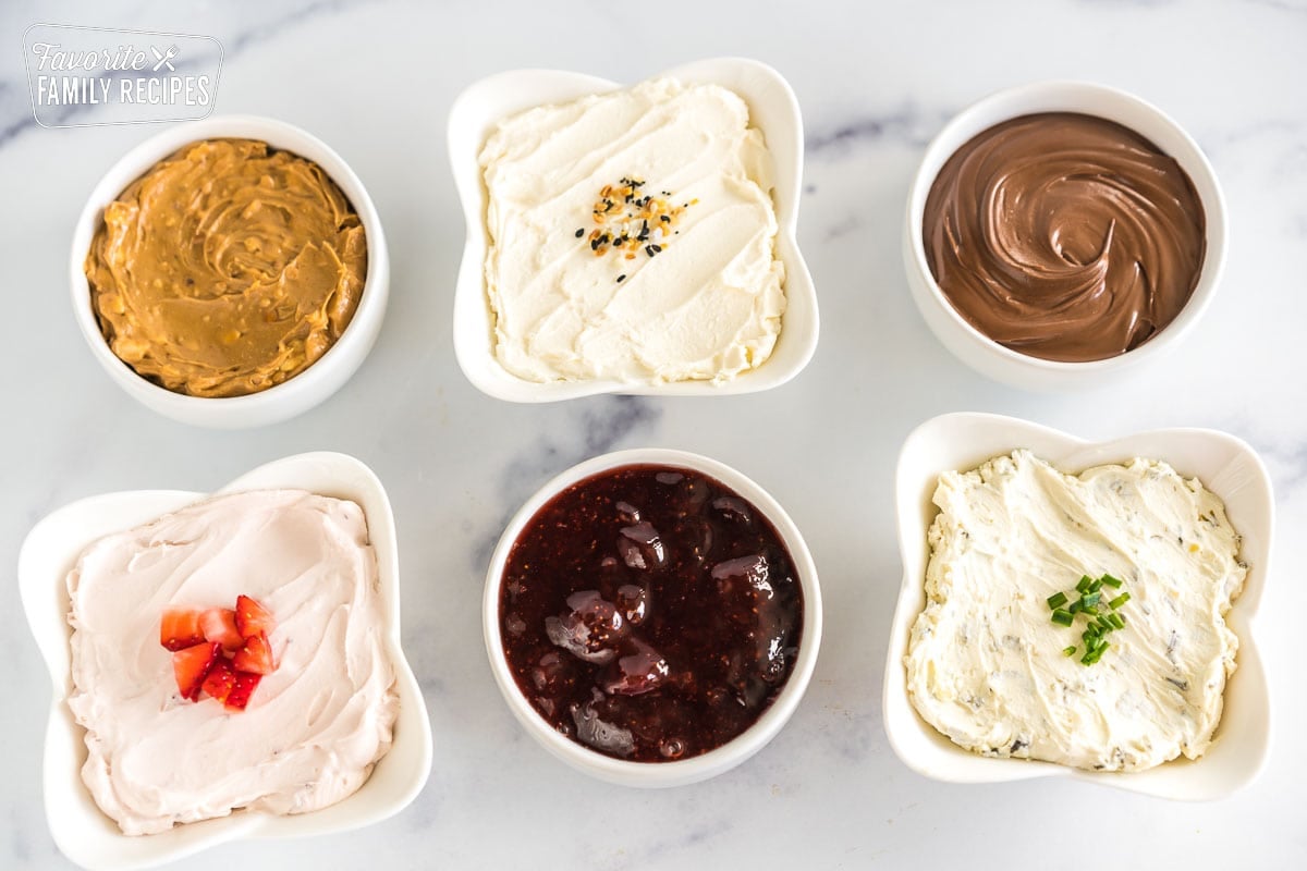 spreads in small bowls for a bagel board