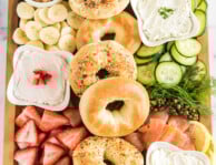 brunch charcuterie board full of bagels, spreads, and toppings