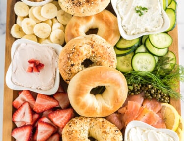 brunch charcuterie board full of bagels, spreads, and toppings