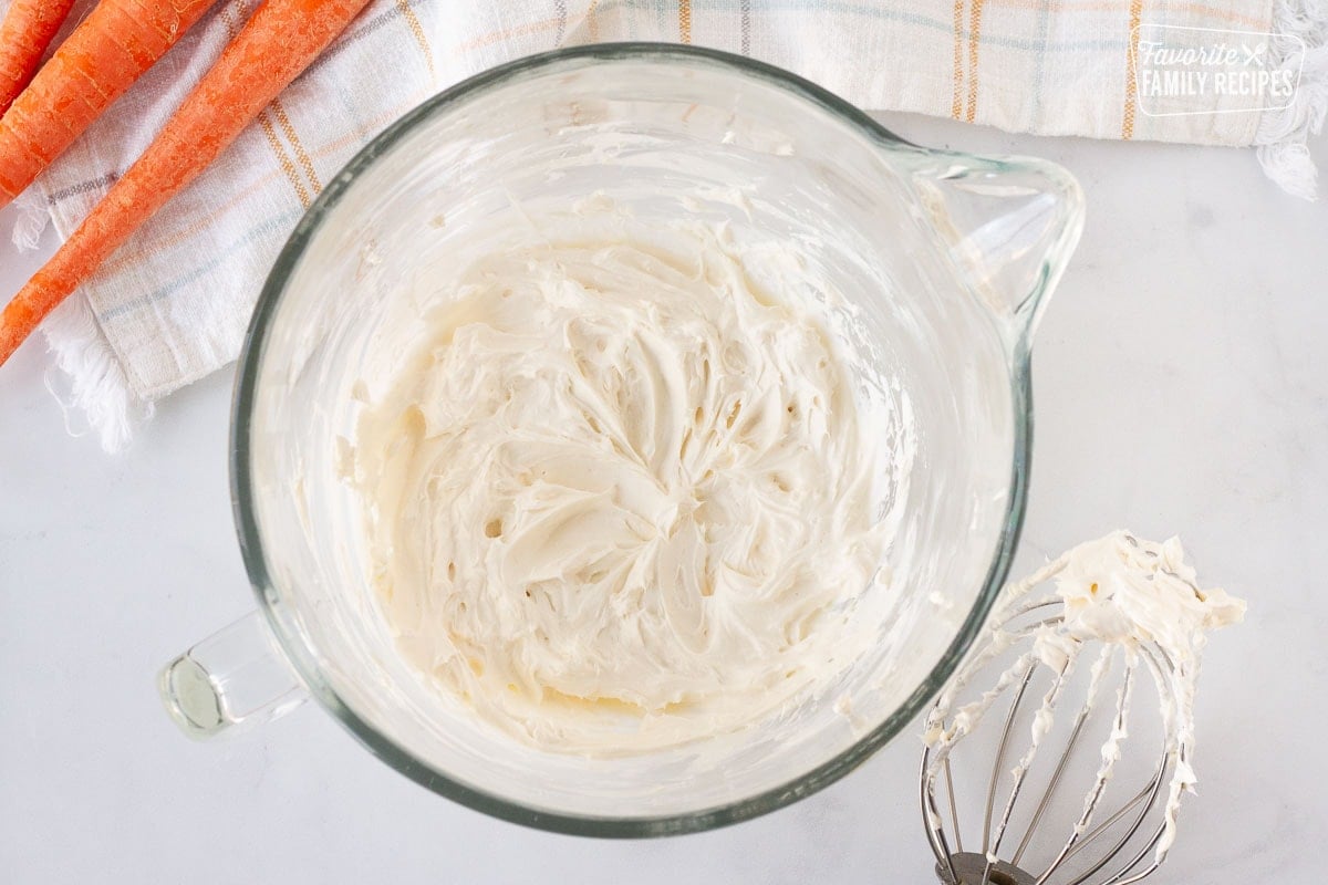 Mixing bowl with cream cheese and butter blended for cream cheese frosting on Carrot Cake Cookies.