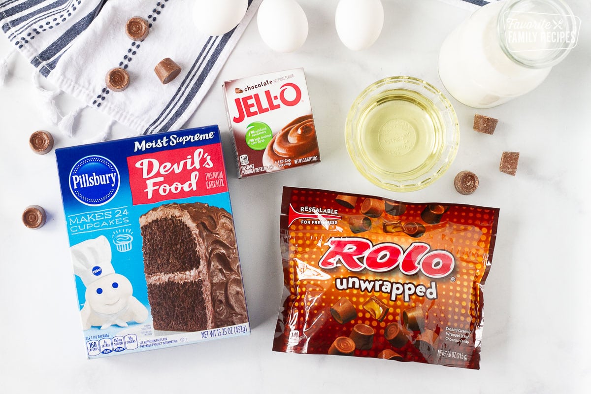 Ingredients to make Crockpot Lava Cake including Rolos, chocolate pudding, milk, oil and Devil's Food cake mix.