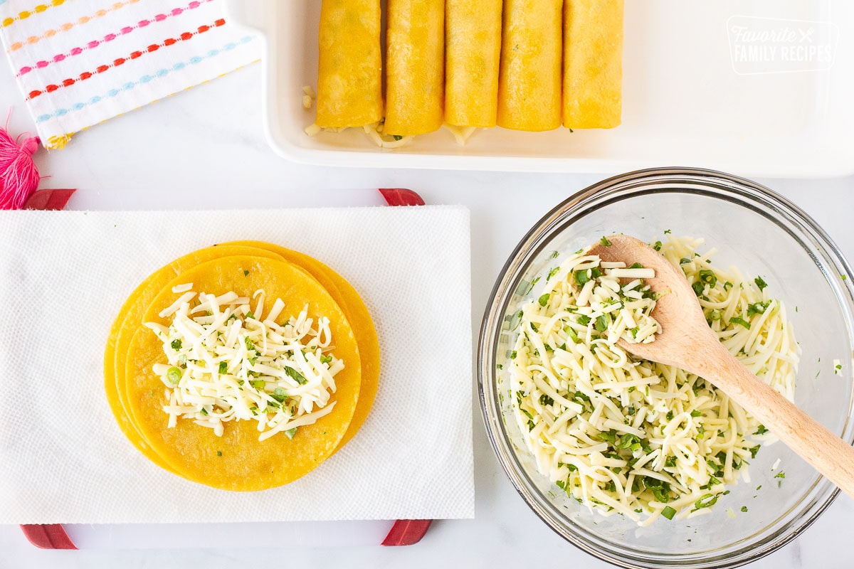 Filling corn tortillas with cheese filling for Easy Cheese Enchiladas.
