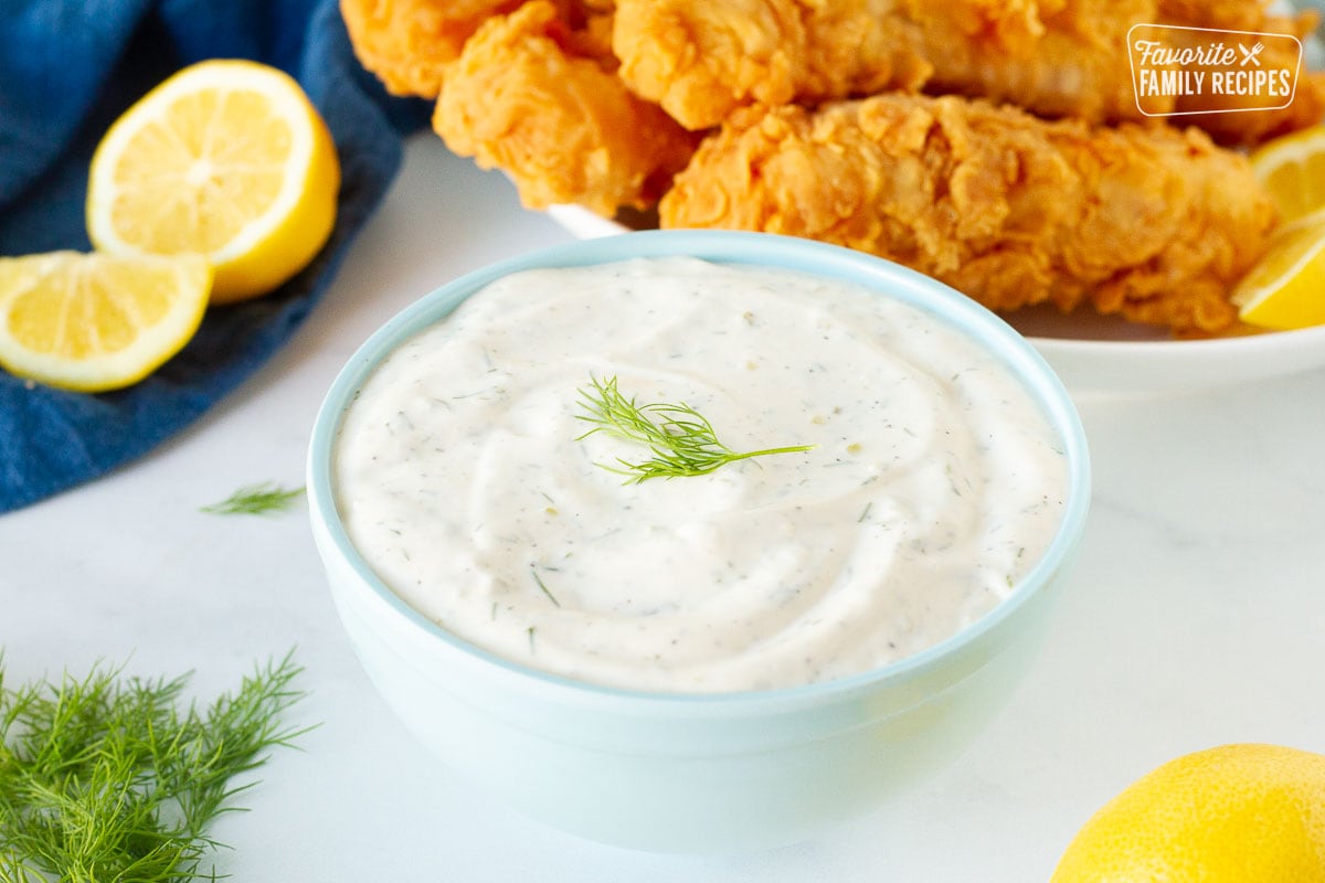 Close up view of Homemade Tartar Sauce in a bowl with fresh dill on top.