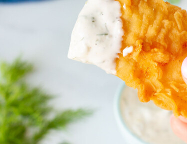 Piece of battered fish with Homemade Tartar Sauce on the top.