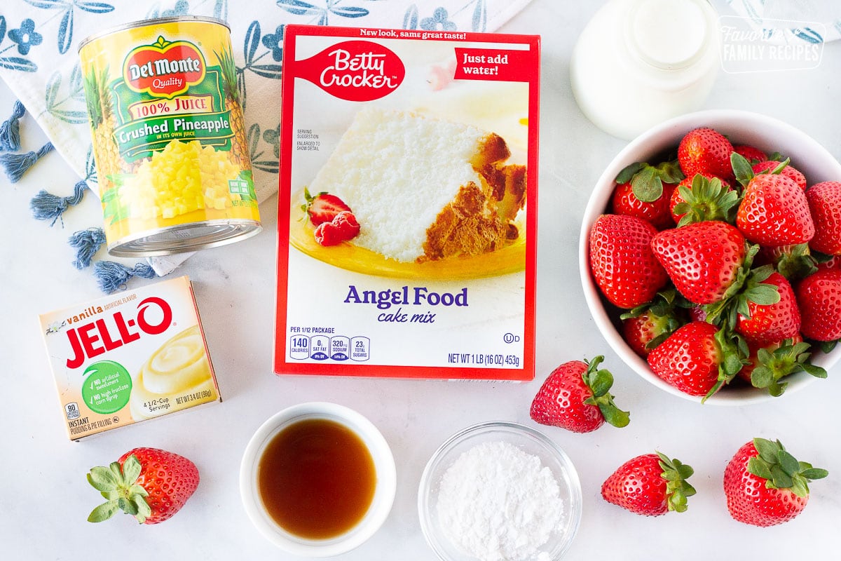 Ingredients for Angel Food Cake including angel food cake mix, crushed pineapple, strawberries, vanilla pudding, vanilla, heavy cream and powdered sugar.