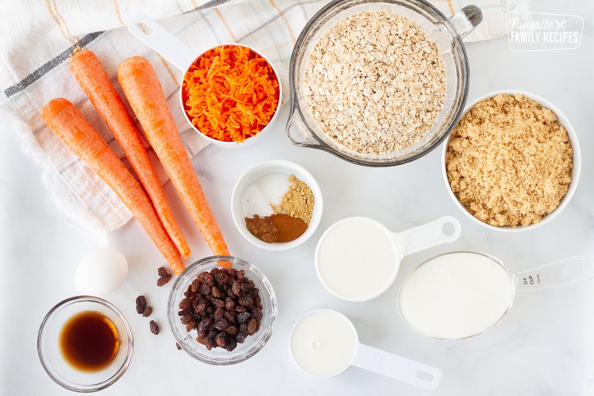 Ingredients for Carrot Cake Cookies including carrots, oatmeal, brown sugar, spices, shortening, milk, sugar, vanilla, egg and raisins.
