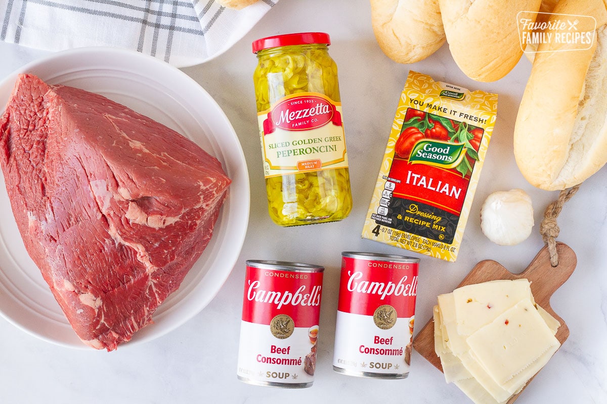 Italian Been Sandwich ingredients including roast, bread rolls, peperoncini, Italian recipe mix, garlic, beef consommé and pepper jack cheese.