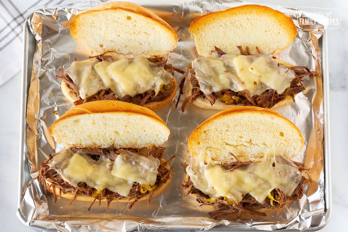 Four lightly toasted rolls with shredded Italian beef and melted pepper jack cheese for Sandwiches.