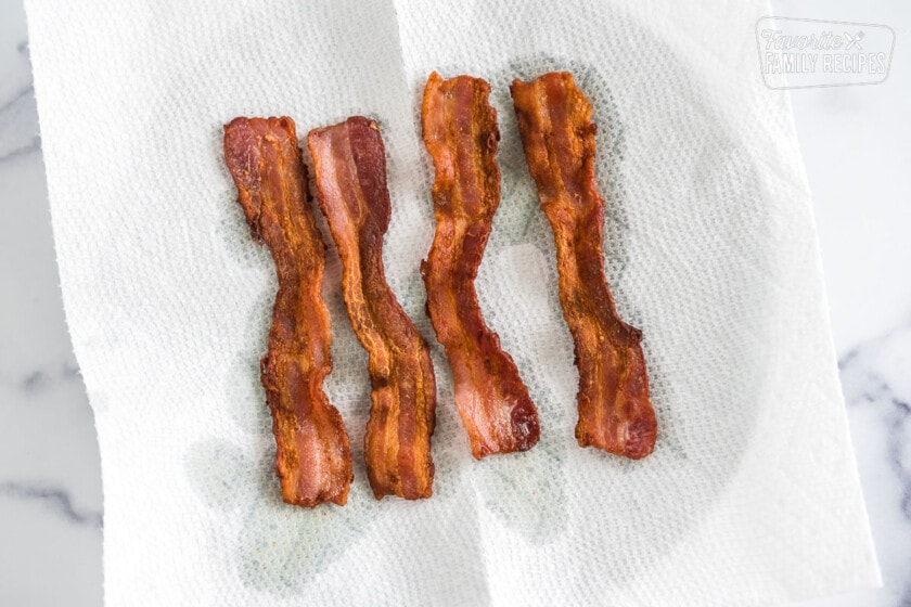 Cooked bacon on a paper towel.