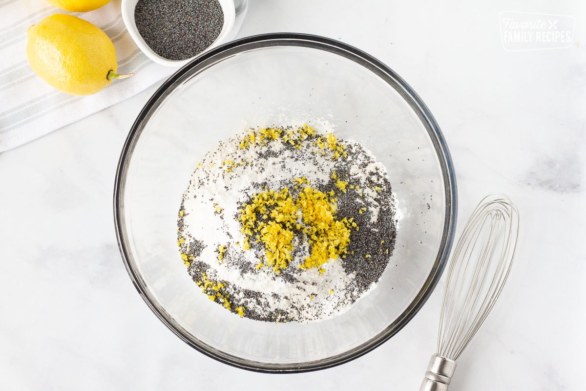 Bowl of flour lemon zest and poppy seeds to make Lemon Poppy Seed Muffins.