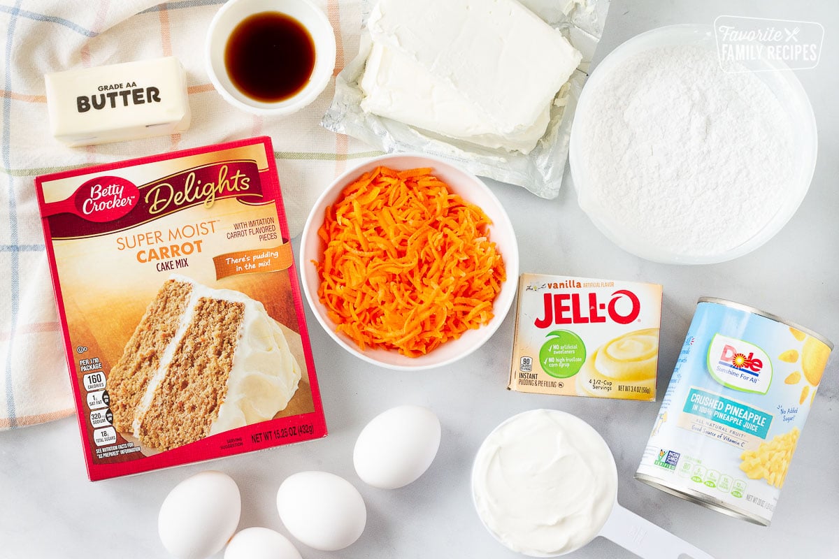 Ingredients to make Carrot Bundt Cake including carrot cake mix, vanilla pudding mix, shredded carrots, vanilla, butter, cream cheese, sugar, sour cream, eggs and crushed pineapple.